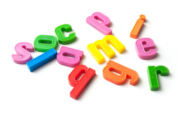 closeup of colorful plastic letters on white background