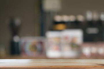 Wooden desk with Blurred of coffe's shop for abstract background