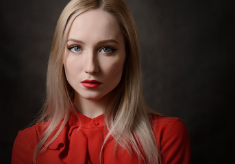 Portrait of a young woman in a red blouse.