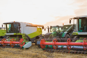 Photo of the combines and tractor in the field