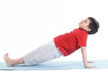 Obraz premium little boy performs morning health gymnastics.isolated on white