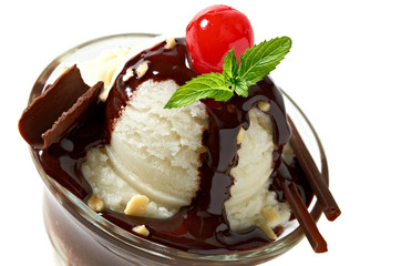 Vanilla sundae ice cream cup with chocolate sauce and maraschino cherry isolated on white background