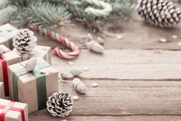 Christmas green branch and gifts on  wooden background