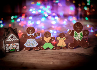 gingerbread house and gingerbread men on a festive background