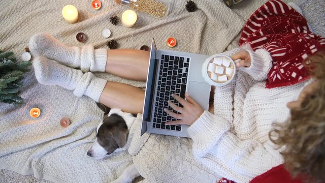 Trendy Top View Of Female Legs In Socks, Dog And Hot Chocolate With Marshmallow.