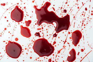 close-up shot of chaotic blood droplets on white