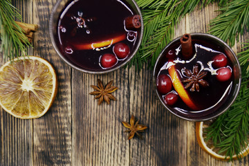 Christmas mulled wine with cranberries in glasses winter warming drink with spices decorated with fir branches cinnamon dried oranges