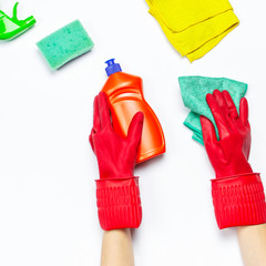 Female hands in red rubber protective gloves with a microfiber cloth isolated on white background top view copy space. Cleaning concept, household, cleaning company, detergents, cleaning accessories