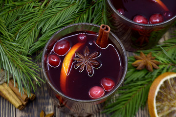 Christmas mulled wine with cranberries in glasses Winter warming drink with spices decorated with...