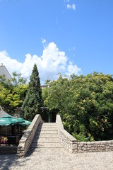 The historic town of Mostar, spanning a deep valley of the Neretva River, developed in the 15th and 16th centuries as an Ottoman frontier town and during the Austro-Hungarian period in the 19th