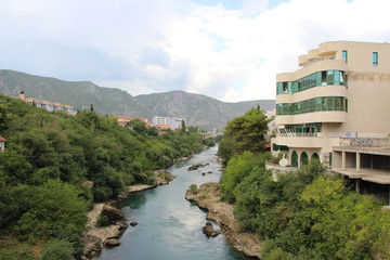 Fototapeta na wymiar The historic town of Mostar, spanning a deep valley of the Neretva River, developed in the 15th and 16th centuries as an Ottoman frontier town and during the Austro-Hungarian period in the 19th