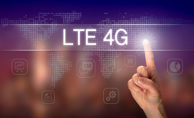 A hand selecting a LTE 4G business concept on a clear screen with a colorful blurred background.
