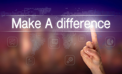 A hand selecting a Make A Difference business concept on a clear screen with a colorful blurred...