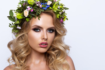 Beautiful Woman with Long Curly Hair, Perfect Makeup and Wreath of Spring Flowers