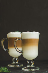 Latte - coffee with milk in a transparent cup on the table. Top view.