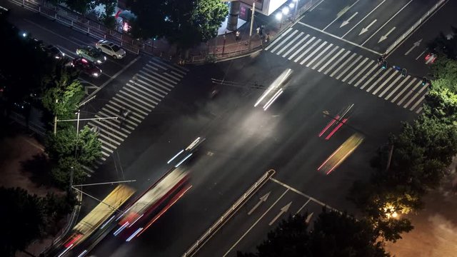 Time lapse of people and traffic crossing busy intersection. Guangzhou, China.