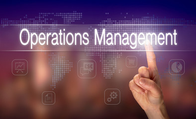A hand selecting a Operations Management business concept on a clear screen with a colorful blurred background.