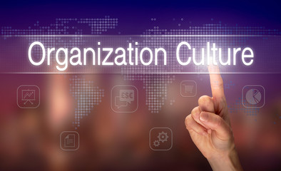 A hand selecting a Organization Culture business concept on a clear screen with a colorful blurred background.