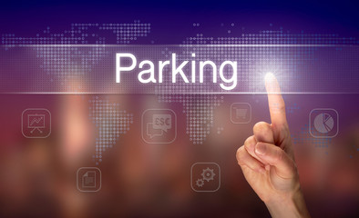 A hand selecting a Parking business concept on a clear screen with a colorful blurred background.