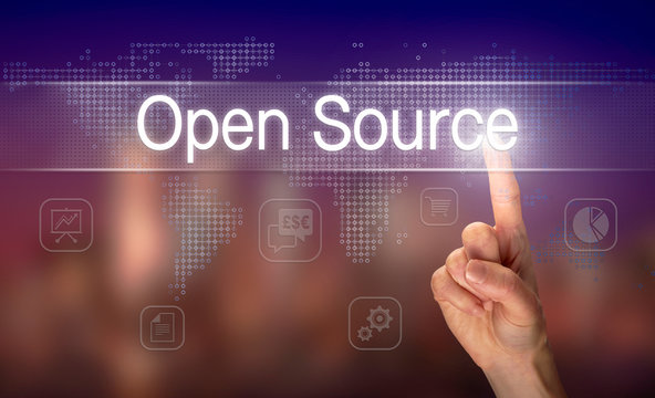 A hand selecting a Open Source business concept on a clear screen with a colorful blurred background.