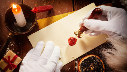 Father Christmas sealing a Christmas letter