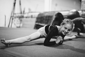 Young gymnast stretching her body