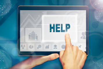 A hand selecting a Help business concept on a computer tablet screen with a colorful background.