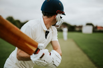 Cricketer on the field in action