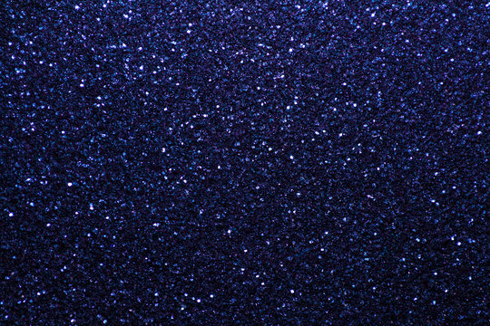 Navy blue sparkling background from small sequins, closeup. Brilliant backdrop.