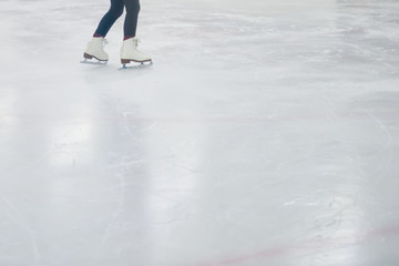 Fototapeta na wymiar Little girls learning to ice skate. Figure skating school. Young figure skaters practicing at indoor skating rink.