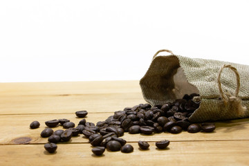 Coffee bean with sack on wooden table.