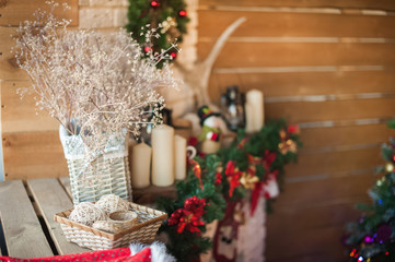 Christmas tree by the fireplace. Scandinavian style bedroom interior under Christmas. Rustic Textured Wooden Bed