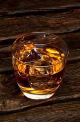 Whisky or whisky in glass on wooden table 