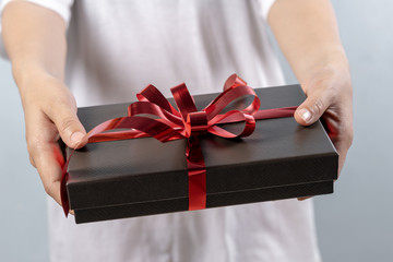 Woman hand holding gift box