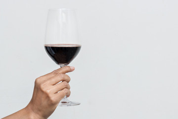 Hand holding a glass of wine