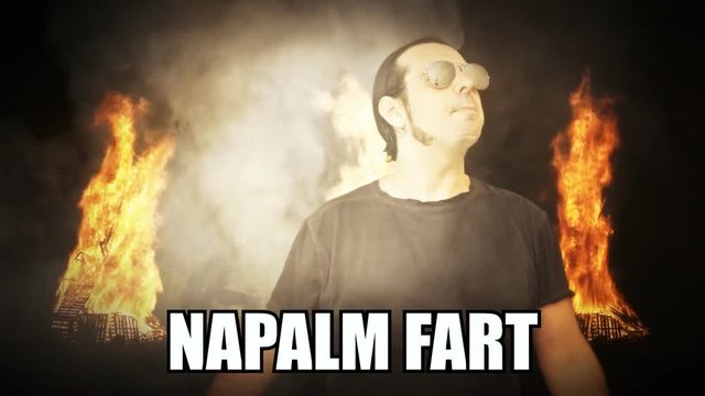 A pop internet culture reaction gif meme: a tough-looking military man rising from the darkness, surrounded by burning fire and smoke clouds, with the caption Napalm Fart.
