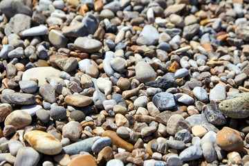 Pebble beach. Multicolored stones on the ocean shore