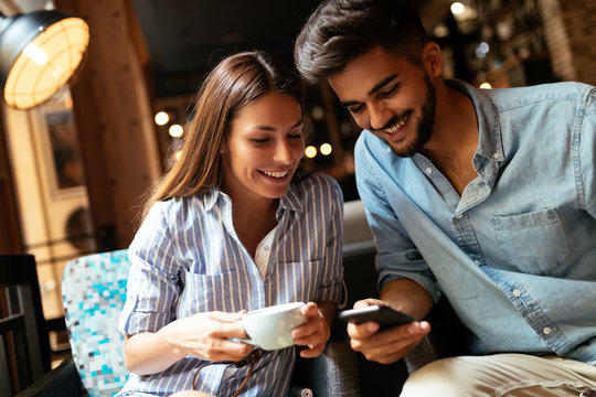 Young attractive couple on date in coffee shop