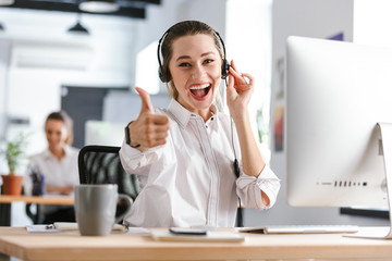 Smiling young woman wearing microphone headset