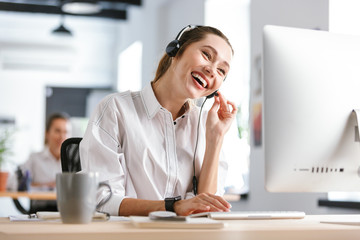 Happy young woman wearing microphone headset - Powered by Adobe
