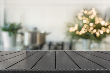 Christmas table background with christmas tree in kitchen out of focus. Background for display your products.