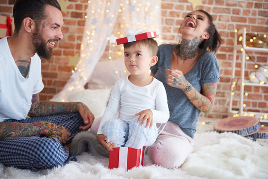 Happy family having fun at Christmas time in bed