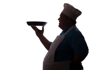 silhouette of a big-bellied happy chef carrying a dish in pan on his hand on a white isolated background