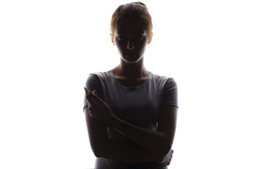 silhouette of a serious and confident young woman looking straight, beautiful girl on a white...