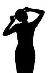 silhouette of a girl listening to music in headphones, figure of woman relaxing on a white isolated background