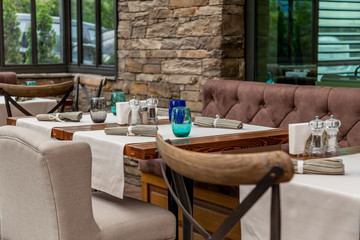 the interior of a refined and well-looking and tidy establishment. modern furnished dining room part of hotel and complex.
