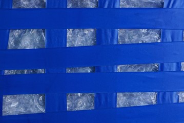 plastic striped texture of blue electrical tape on white cellophane