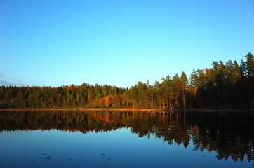 Nature of Sweden in autumn, Calm lake Kolpen with forest reflection, Peaceful outdoor image, Along the hiking trail Bruksleden in october