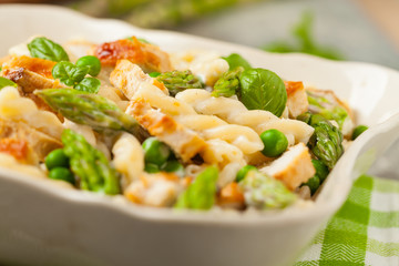 Italian pasta fusilli. Salad with chicken and asparagus in Béchamel sauce.