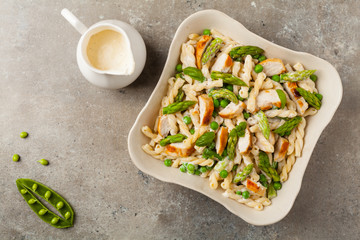 Italian pasta fusilli. Salad with chicken and asparagus in Béchamel sauce.
